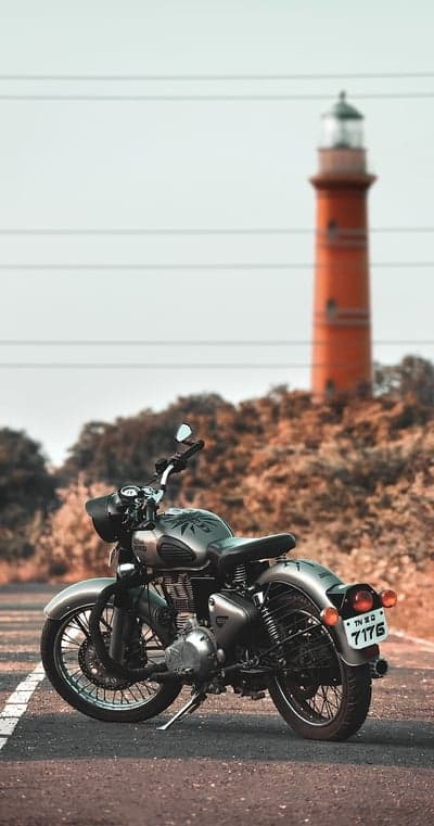 Vintage Motorcycle and Lighthouse on Coastal Road