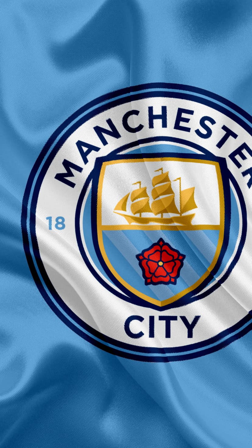 Manchester City FC crest featuring a ship and red rose centered on wavy light blue fabric with soft shadows.