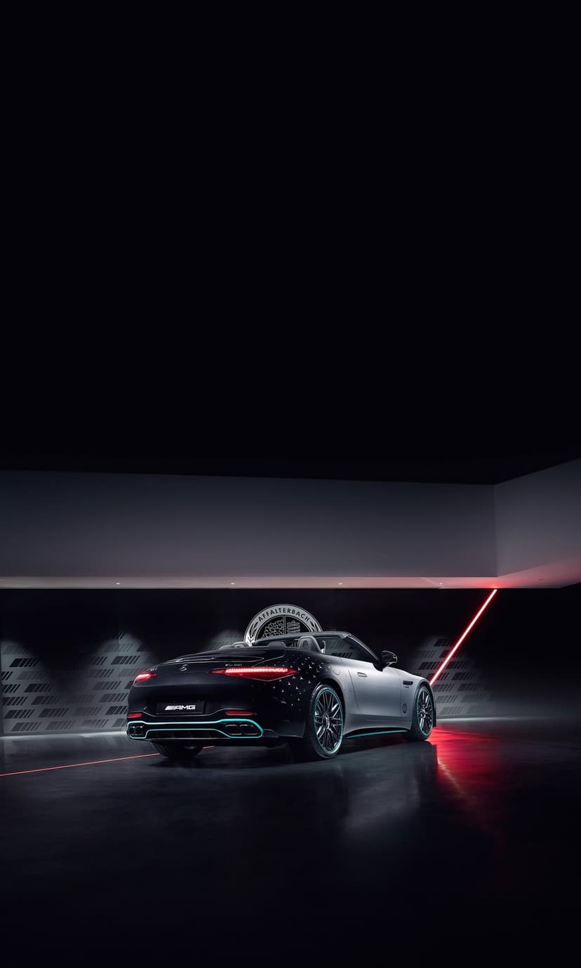 Mercedes-AMG SL 63 rear with glowing red taillights and laser beams in a dark modern studio environment.