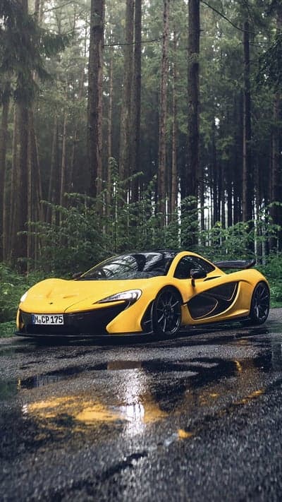 Vibrant McLaren P1 Hypercar in Moody Rain Forest Background