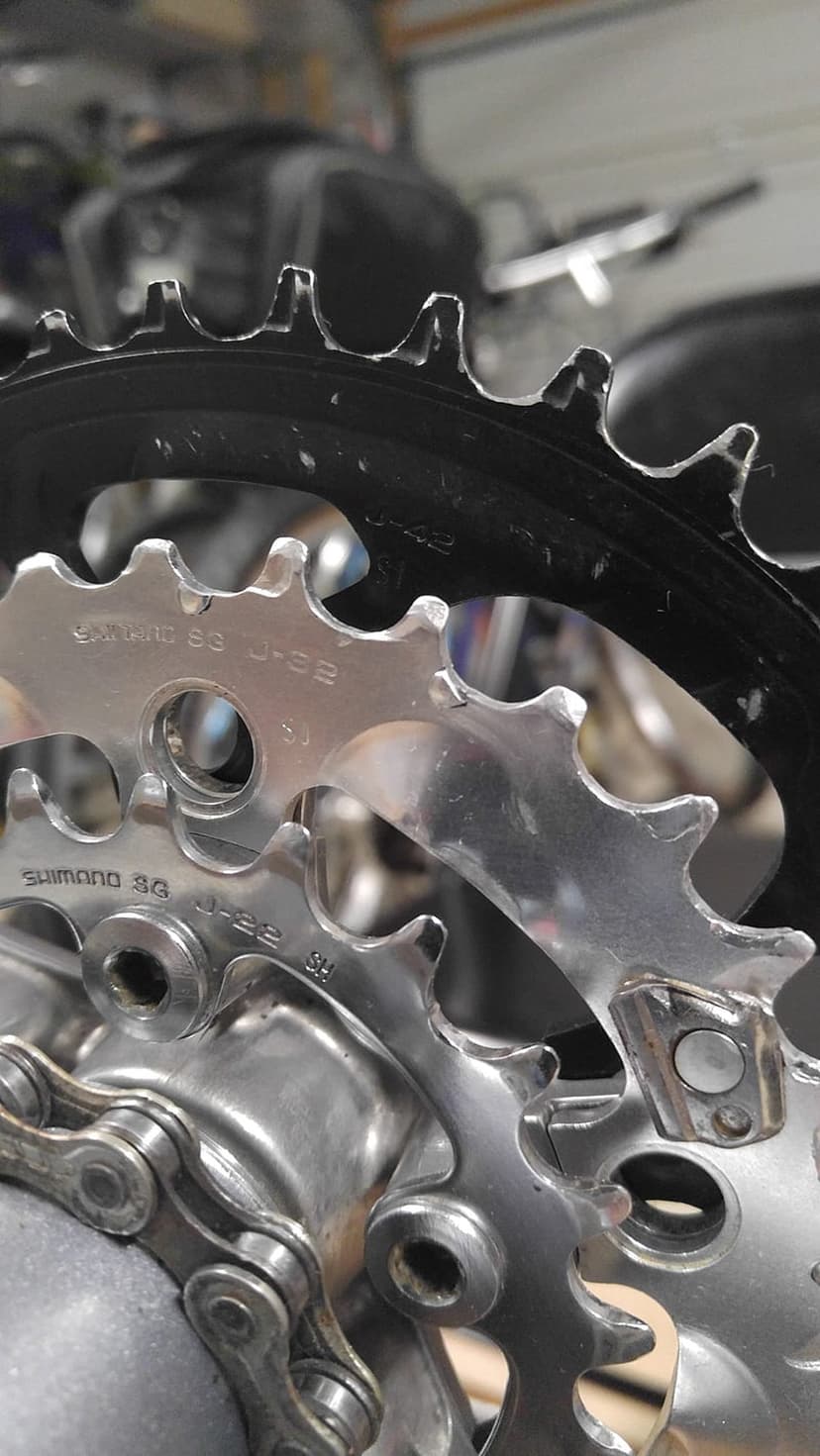 Shimano bicycle chainrings and silver metal chain links in a macro shot designed for vertical mobile wallpapers.