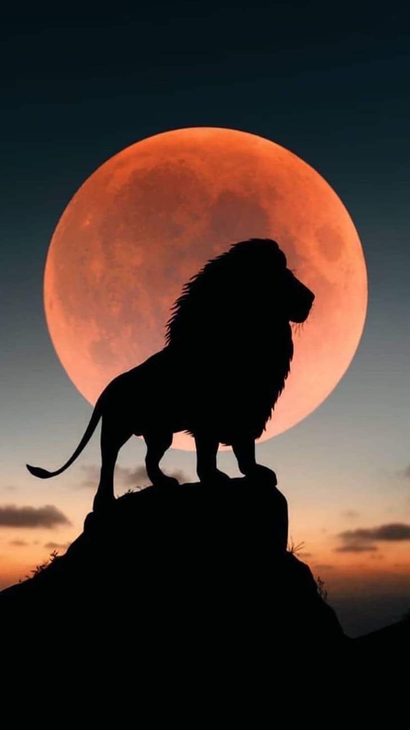Lion silhouette standing on a rocky peak before a massive glowing red blood moon in a dark twilight sky.