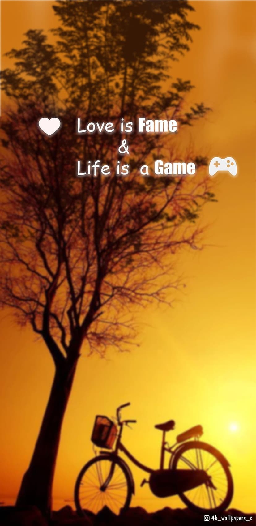 Silhouetted bicycle and bare tree stand against a glowing orange sunset sky with a heart and game controller.