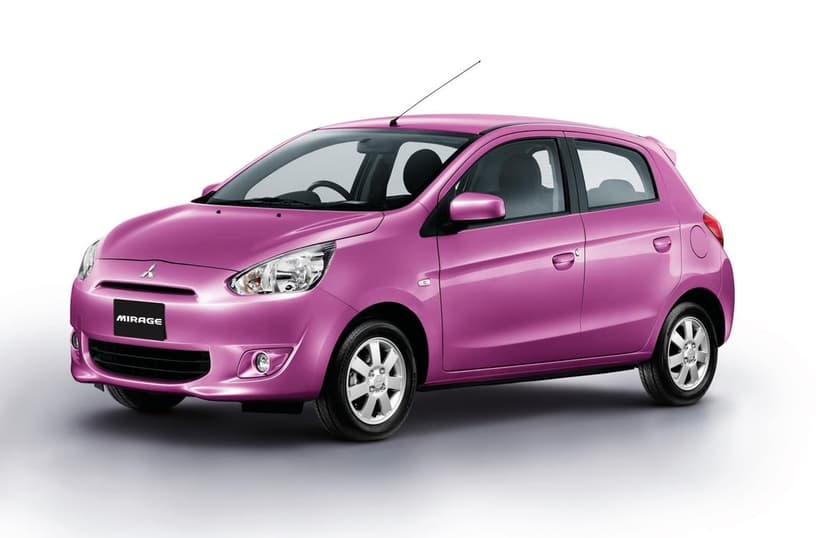 Pink Mitsubishi Mirage hatchback centered on a clean white studio background with soft natural lighting and shadows.