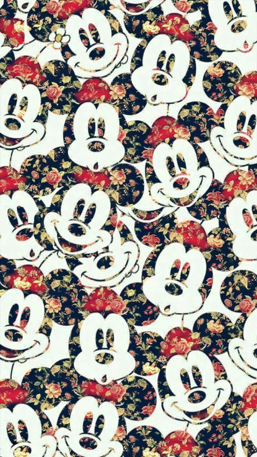 Mickey Mouse silhouettes nestled among red and yellow roses on a navy blue botanical wallpaper background.
