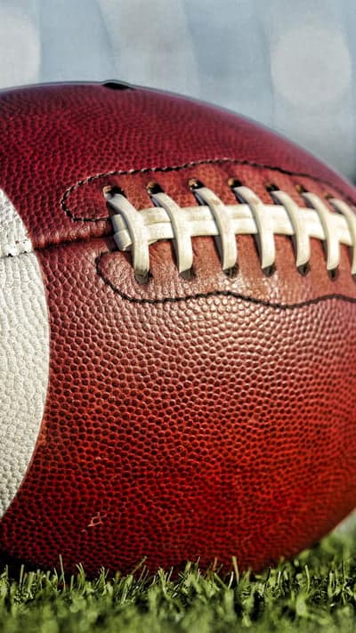 Close-up of American Football on Green Grass
