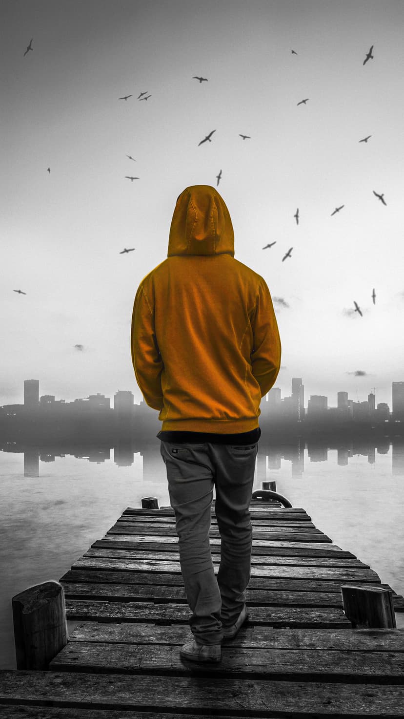 Masked figure wearing a dark hood stands in a misty urban street under glowing violet and blue neon city lights.