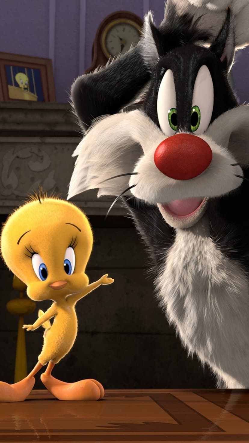 Sylvester the Cat gazes in shock at Tweety Bird on a wood table near a grandfather clock and wall portrait.