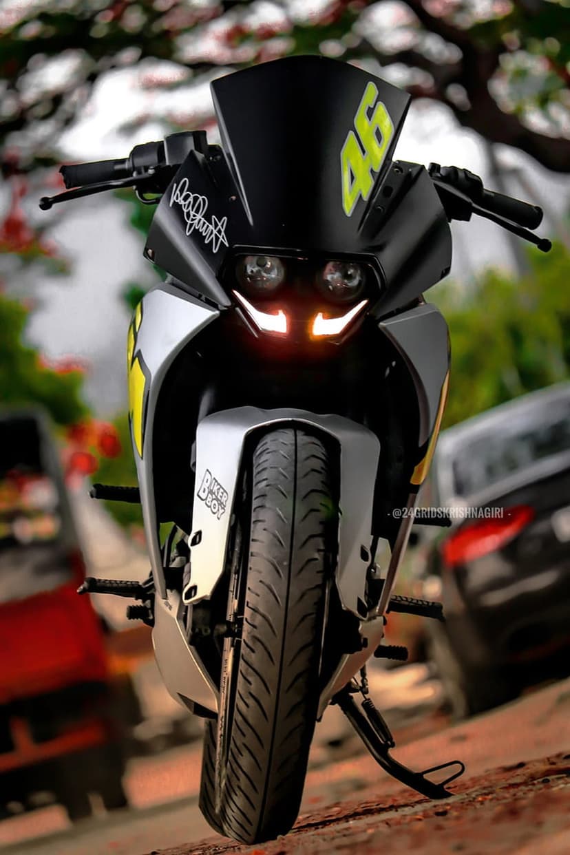 KTM RC 390 front profile with illuminated LED headlights and a yellow Valentino Rossi 46 decal on the windshield.