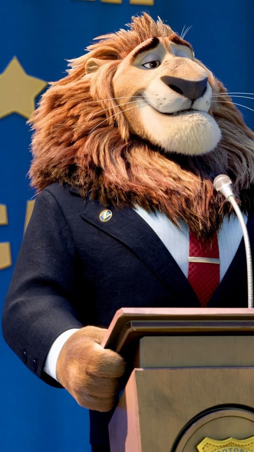 Mayor Leodore Lionheart wearing a navy suit speaks at a wooden podium against a starry blue curtain background.