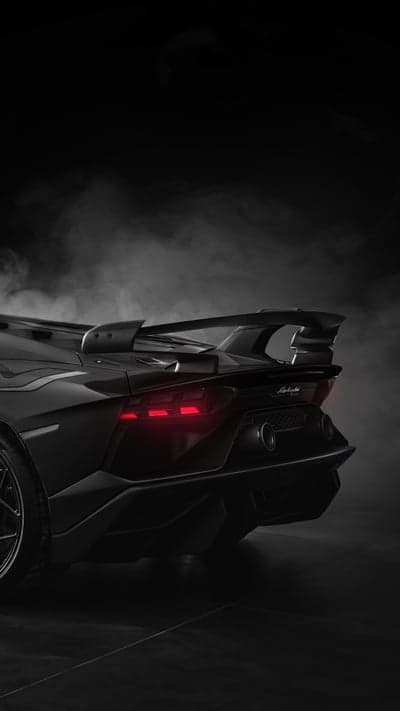 Black Lamborghini with Red Taillights and Smoke