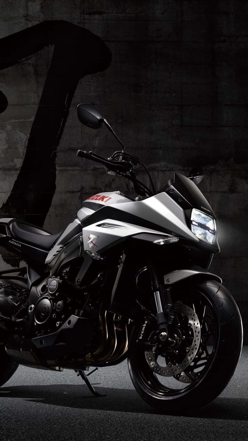 Suzuki Katana motorcycle featuring sharp silver bodywork and a distinctive front fairing against a neutral backdrop.