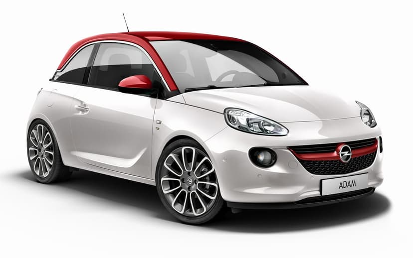 White Opel Adam hatchback with a red roof and mirrors against a white background with soft studio lighting.