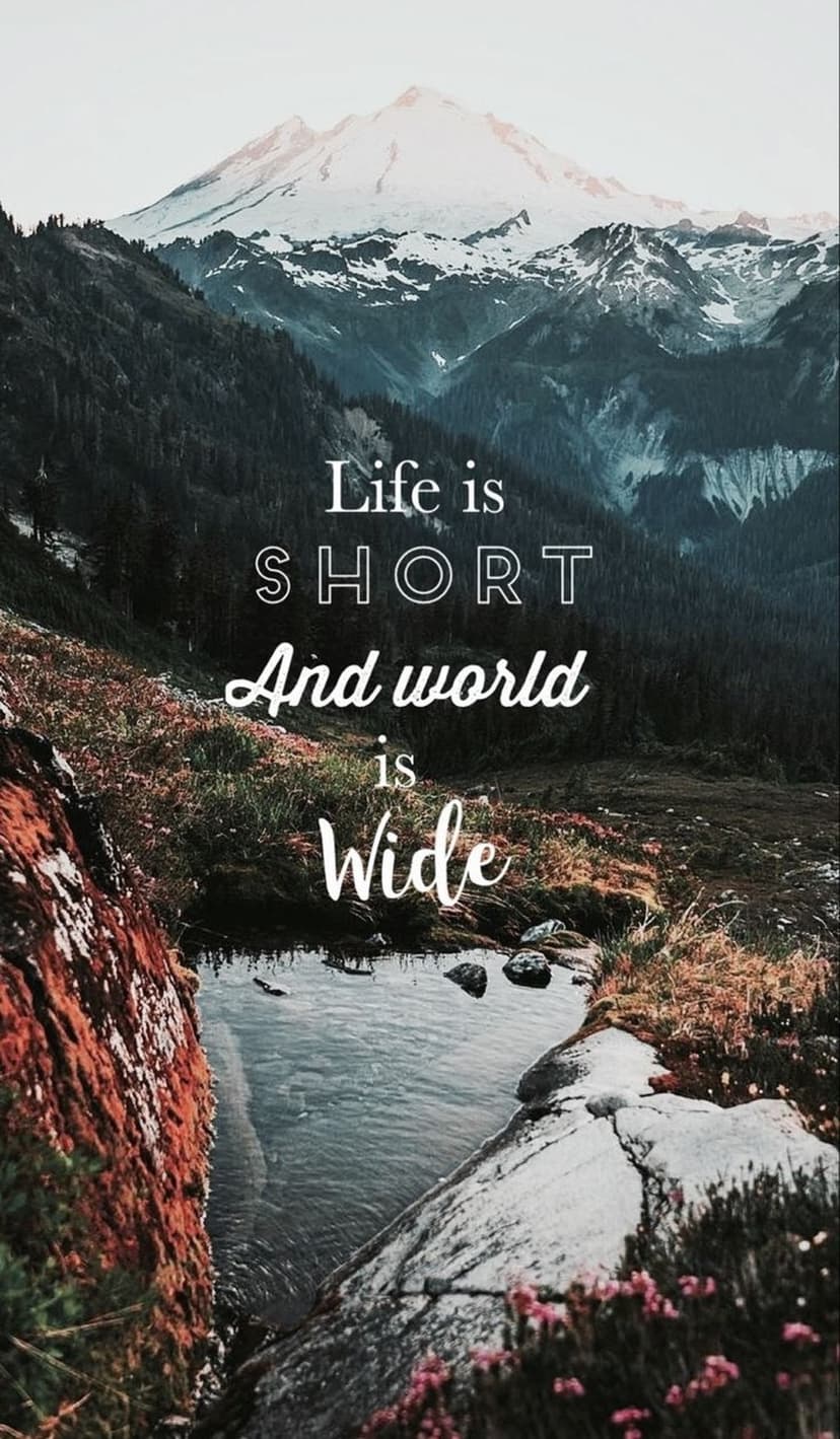 Snow-capped mountain peaks tower over a green pine forest with the text Life is short and world is wide overlaid.