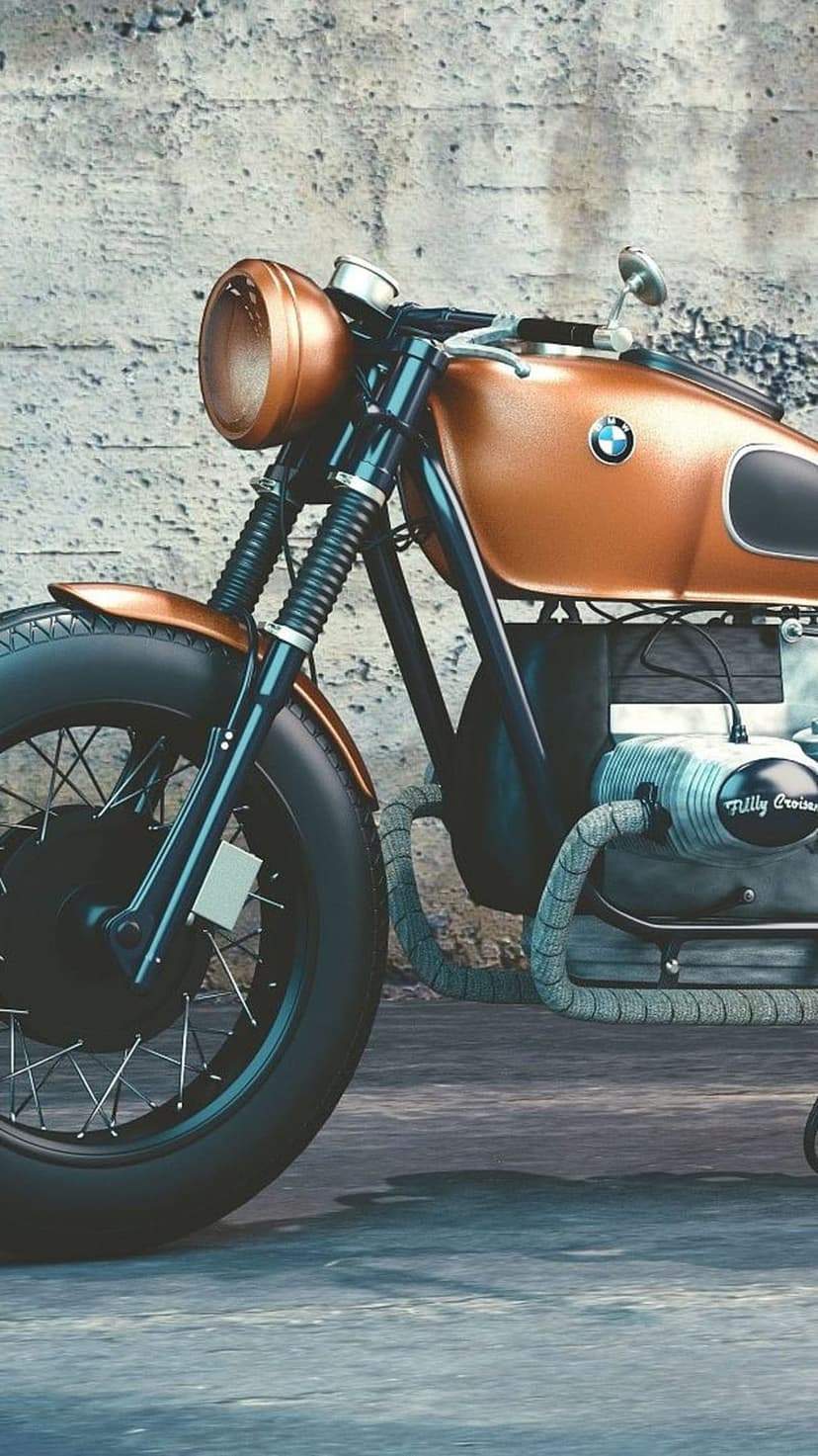 Copper BMW cafe racer motorcycle with black spoke wheels parked against a textured gray concrete wall.