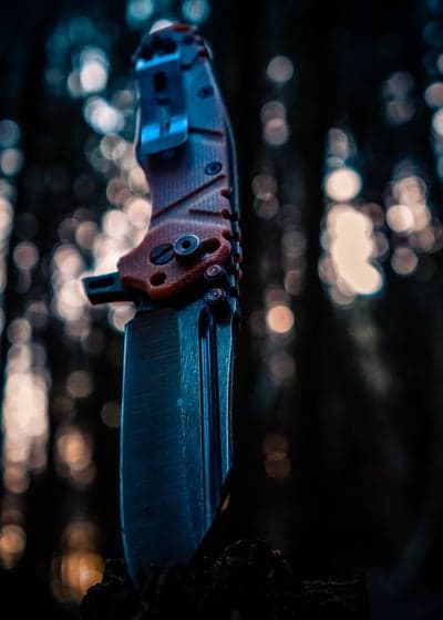 Close-up of a tactical folding knife with bokeh background
