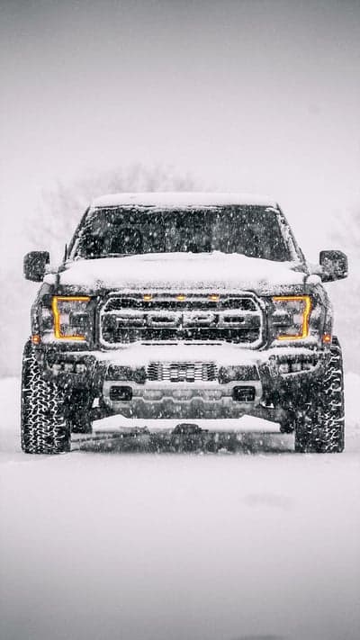 Ford Raptor Truck Driving in Heavy Snowstorm