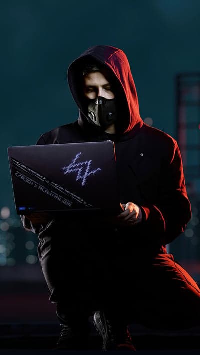 Alan Walker and ROG laptop with neon 'AW' logo