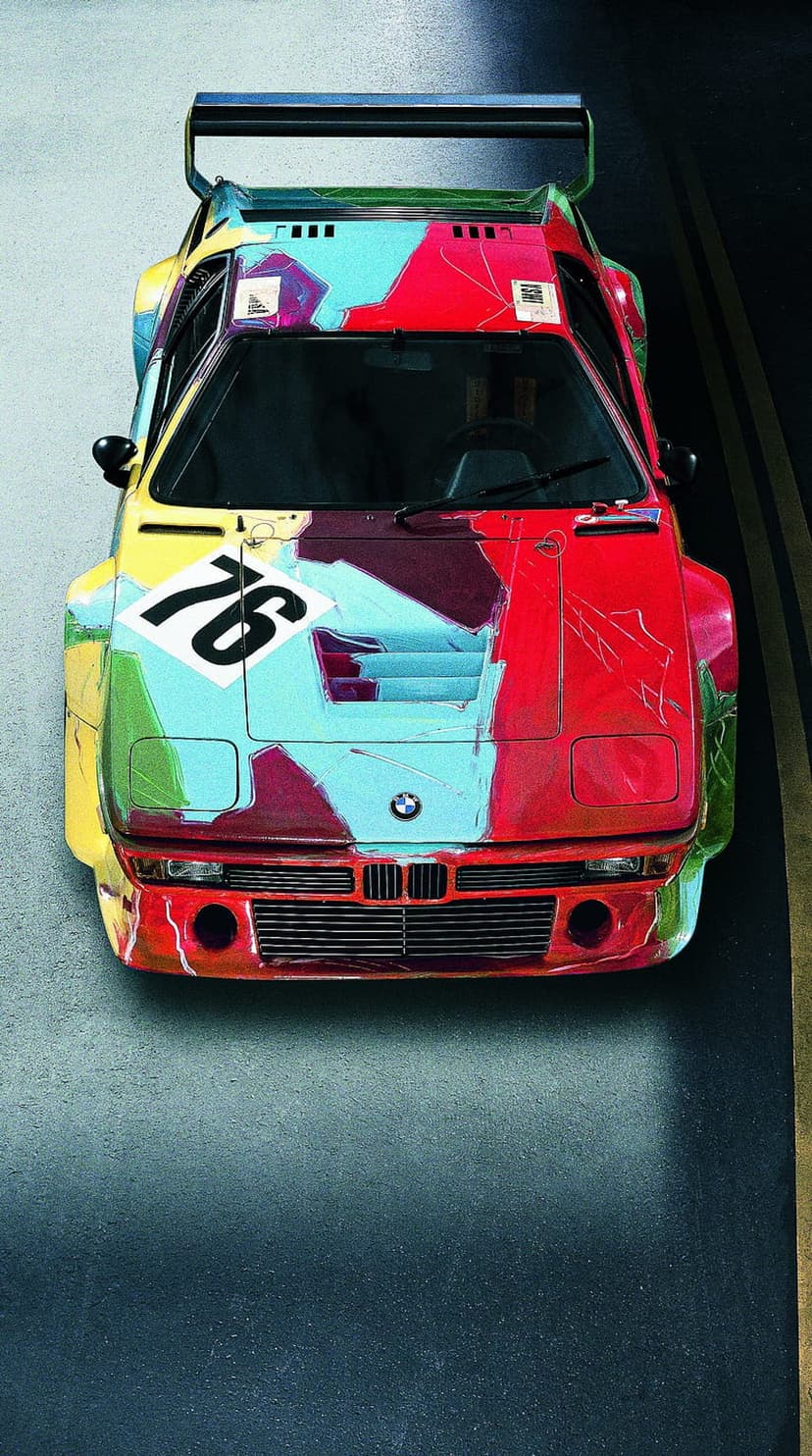 BMW M1 race car painted with colorful abstract brushstrokes by Andy Warhol for a vertical screen display.
