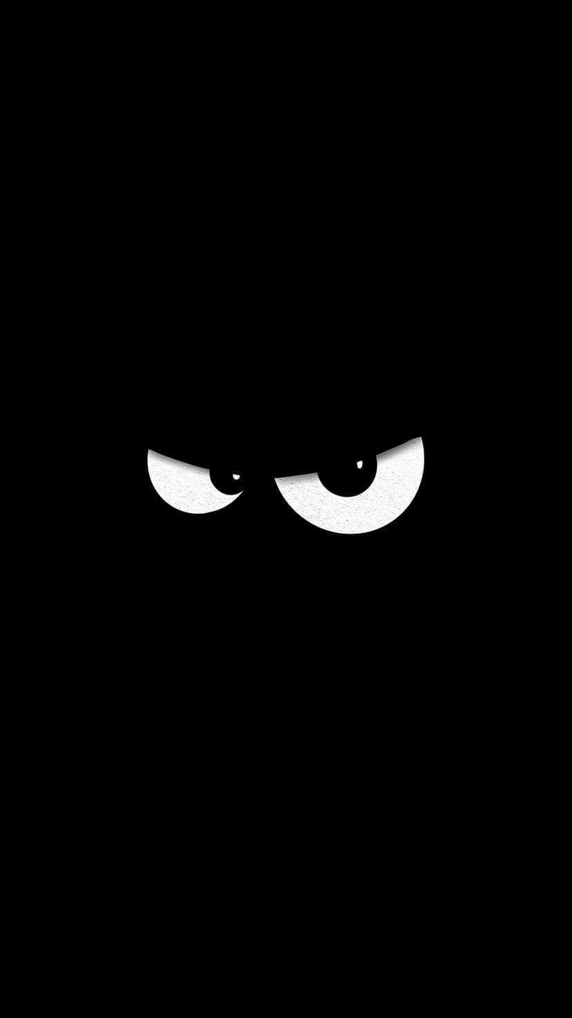 Large glowing white eyes with black pupils stare intensely forward from a deep, solid black background.