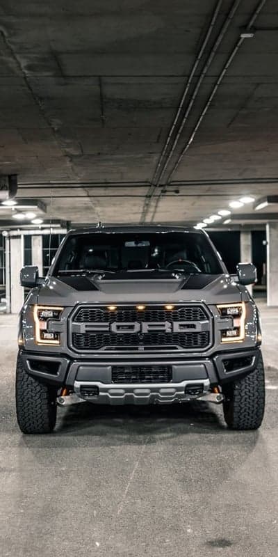 Ford F-150 Raptor parked in a concrete garage