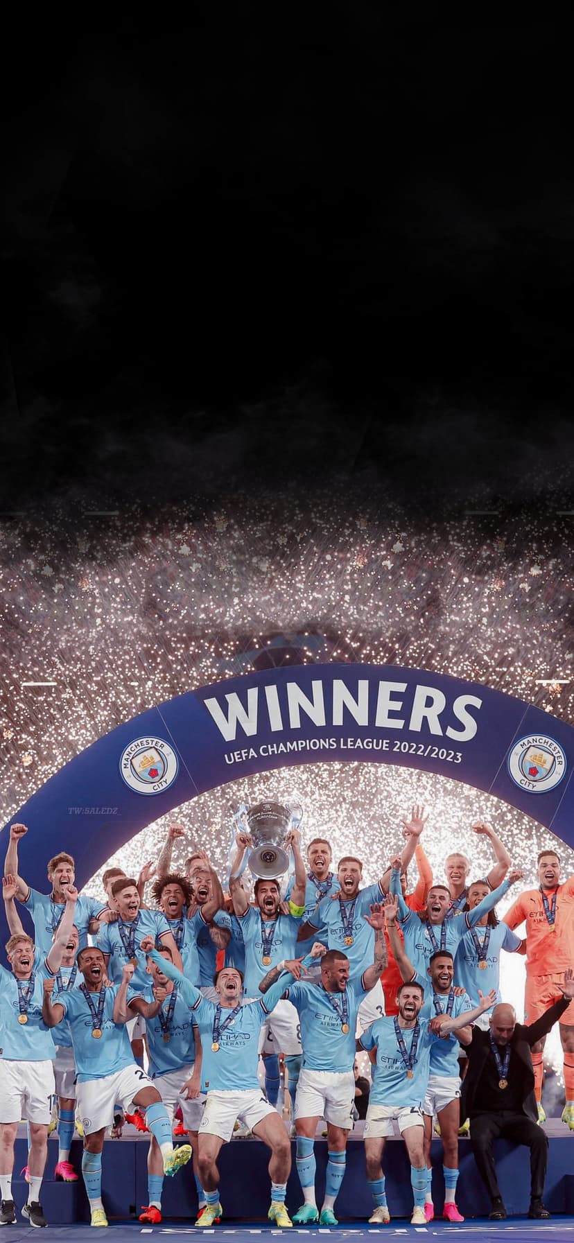Manchester City players lift the silver Champions League trophy under glowing fireworks and falling confetti.