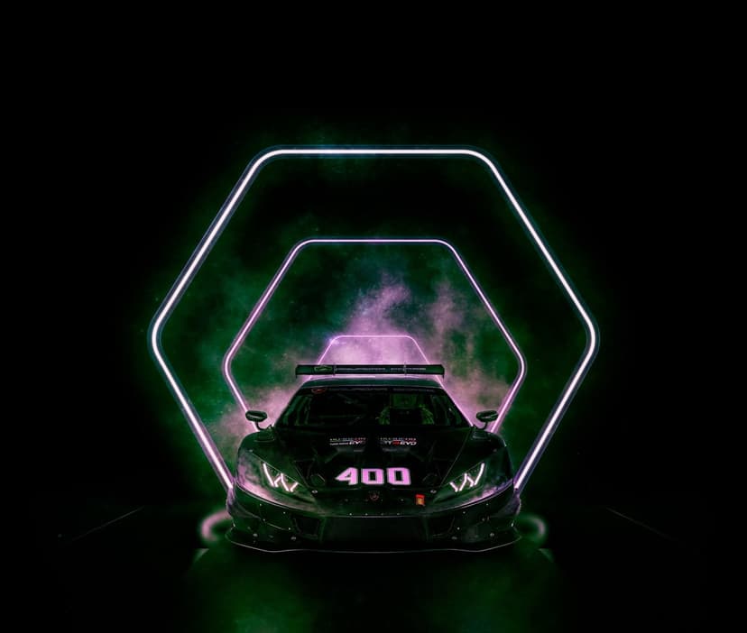 Black race car with number 400 on the hood exiting a glowing neon hexagonal tunnel filled with purple smoke.