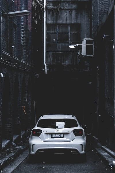 White Mercedes-Benz in Dark Urban Alleyway at Night