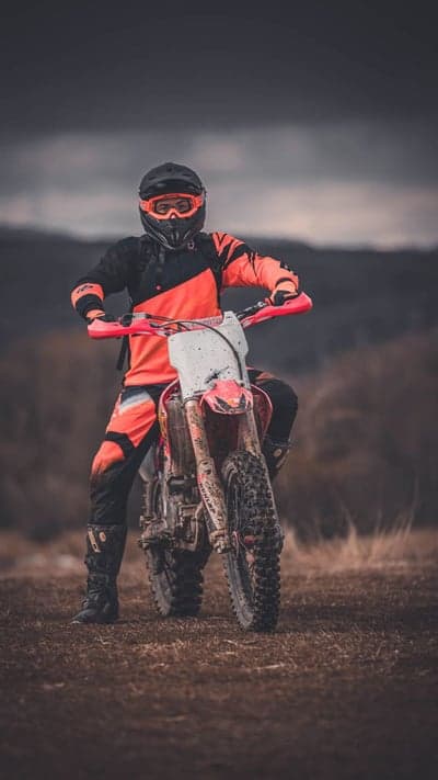 Motocross Rider on Dirt Bike in Outdoor Setting