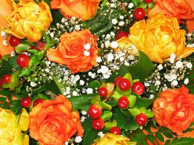 Vibrant Orange and Yellow Roses with Berries and Baby's Breath