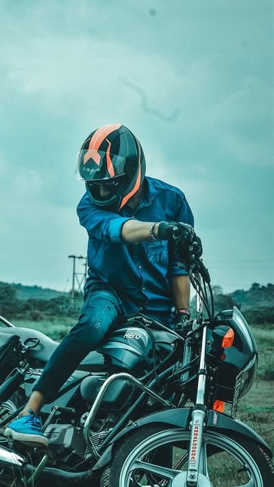 Cinematic Biker in Orange Helmet Mobile Phone Wallpaper