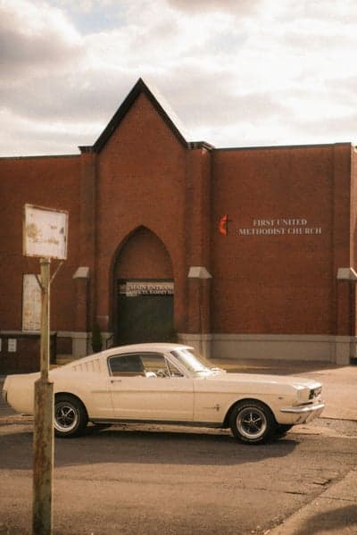 Cream 1960s Ford Mustang and Brick Church Phone Backdrop