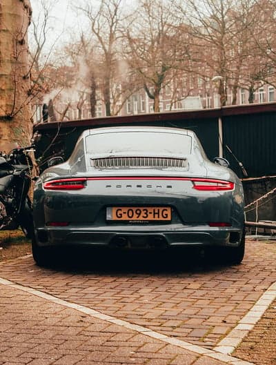 Sleek Porsche 911 Rear in Urban Grey Phone Wallpaper