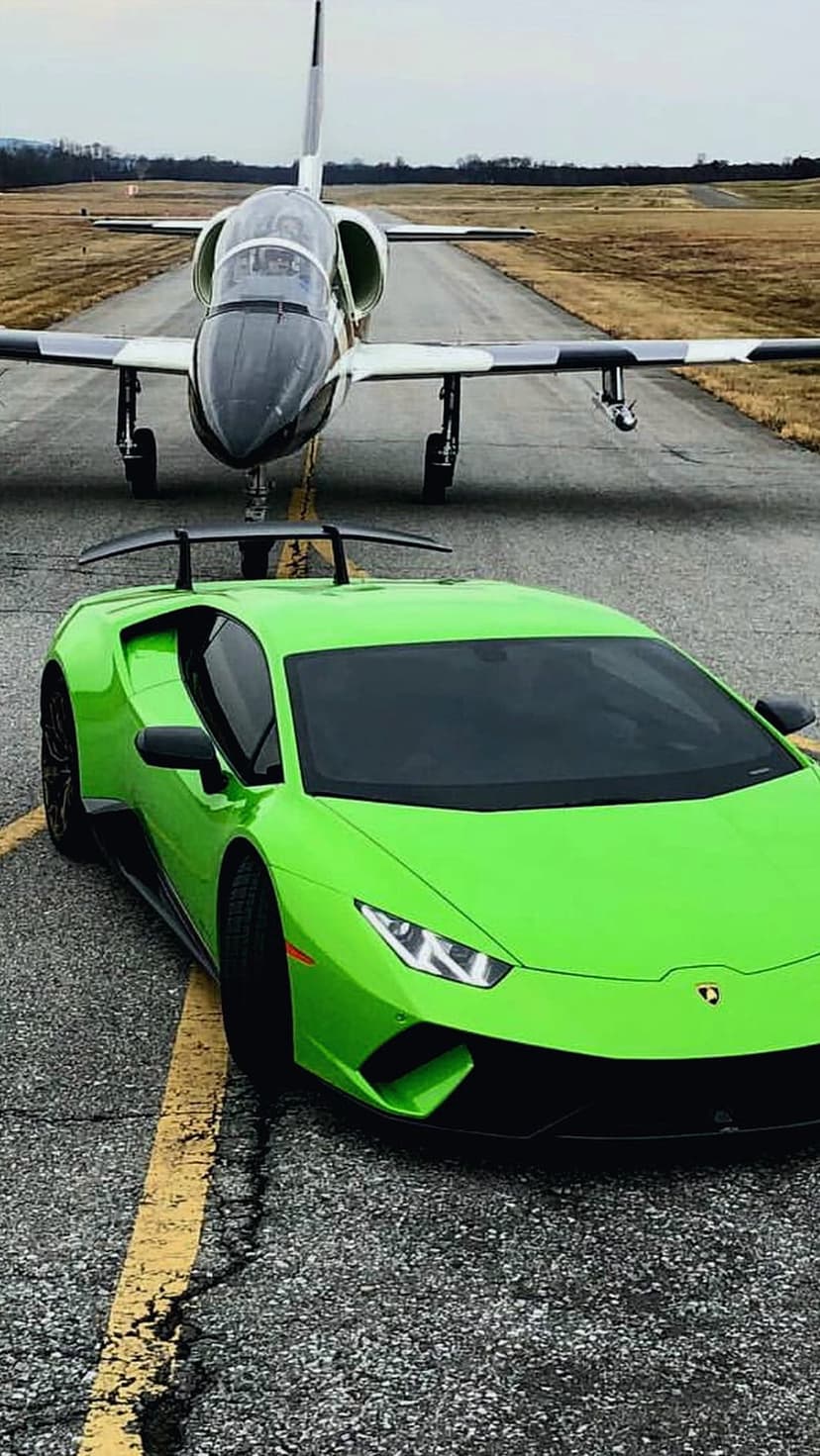 Green Lamborghini Huracan Performante parked on an airfield runway in front of a sleek executive private jet.