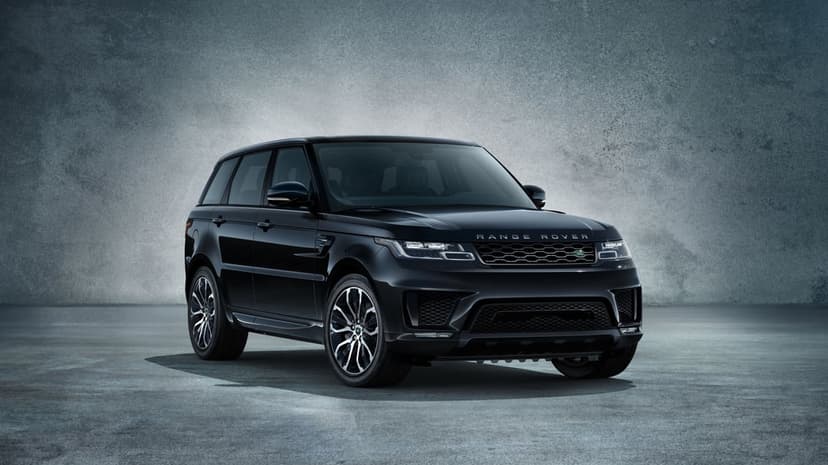 Black Range Rover Sport SVR luxury SUV in a grey industrial studio with soft overhead lighting and reflections.