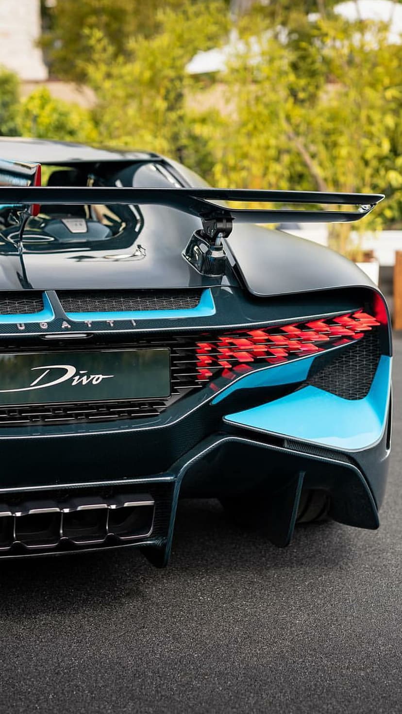 Bugatti Divo rear LED taillights with red and blue accents next to a large carbon fiber spoiler.