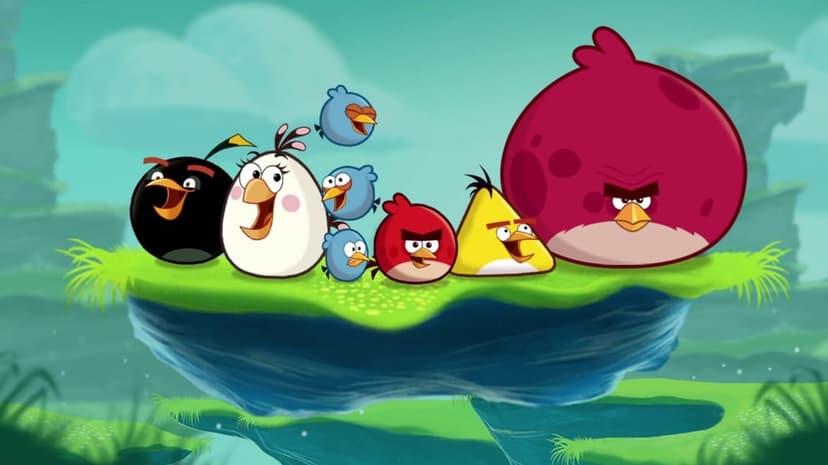 Angry Birds characters Red, Chuck, and Bomb stand on a floating grassy island against a teal cartoon landscape.