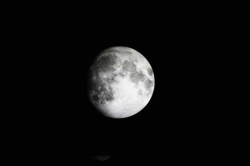 Full moon with visible craters and lunar maria centered against a solid black background in high detail.