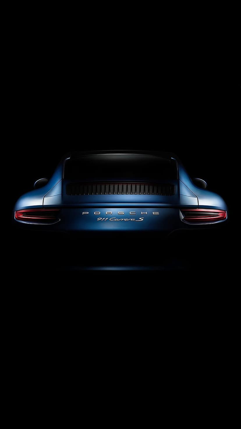 Porsche 911 Carrera S rear view with illuminated red taillights and blue metallic paint on a black background.