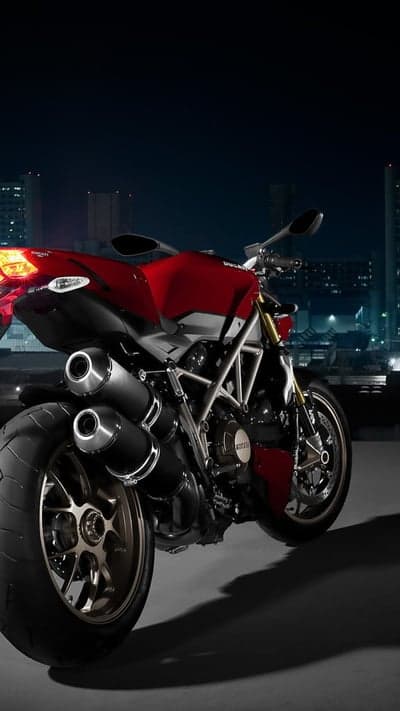 Red Ducati Motorcycle at Night Cityscape