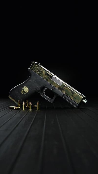 Camouflaged Pistol with Skull Emblem and Ammunition