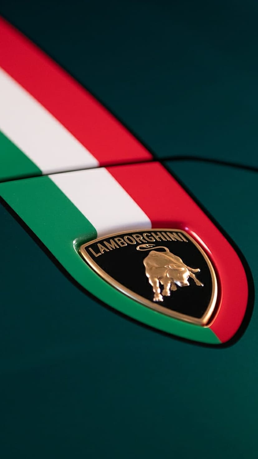 Lamborghini golden bull emblem on a black shield next to a green white and red stripe on dark green car paint.