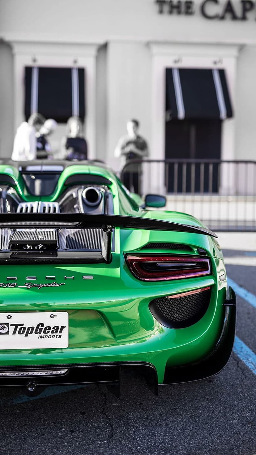 Porsche 918 Spyder in acid green featuring a black spoiler, LED taillights, and top-exit exhaust pipes.