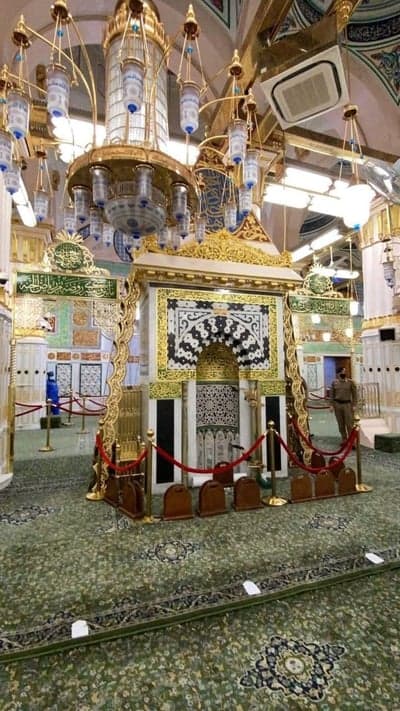 Interior of Mosque with Ornate Chandelier and Green Carpet