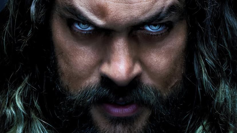 Aquaman Jason Momoa stands underwater wearing intricate gold armor featuring detailed scales and cinematic lighting.