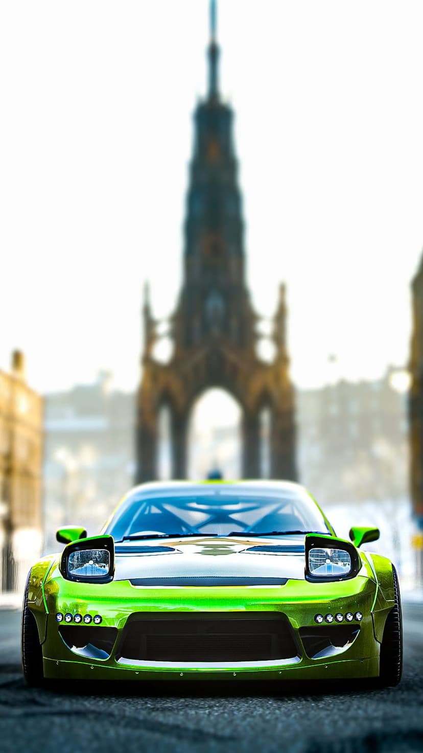 Lime green sports car with glowing pop-up headlights parked on an urban street near a dark gothic monument.