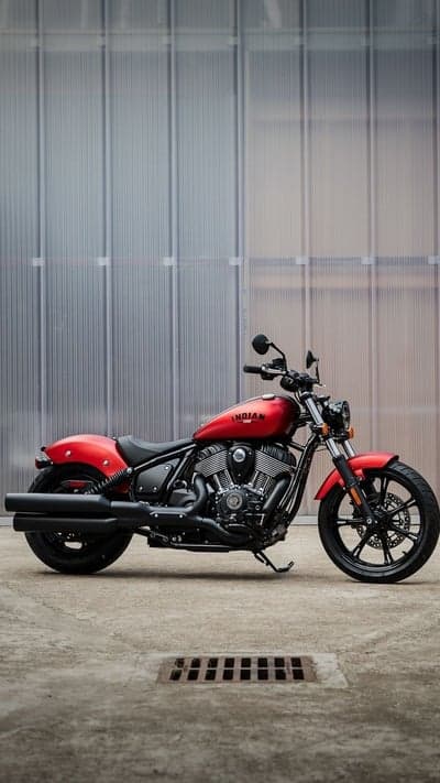 Red Indian Motorcycle parked against ribbed modern wall