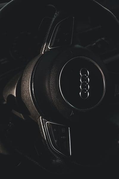 Close-up of Audi steering wheel interior, dark lighting
