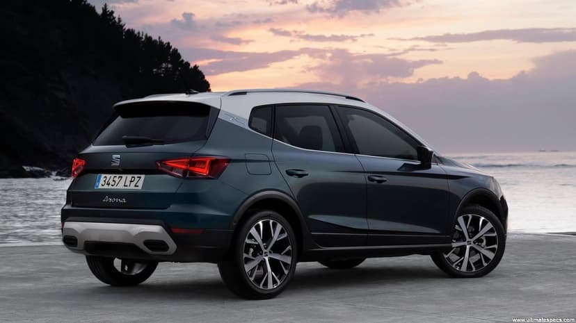 Rear view of a teal SEAT Arona SUV with a silver roof on a coastal road during a pink sunset.