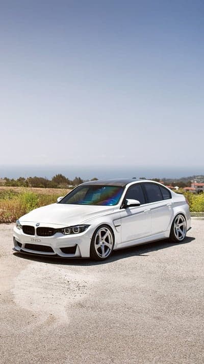 White BMW M4 Coupe on Coastal Road